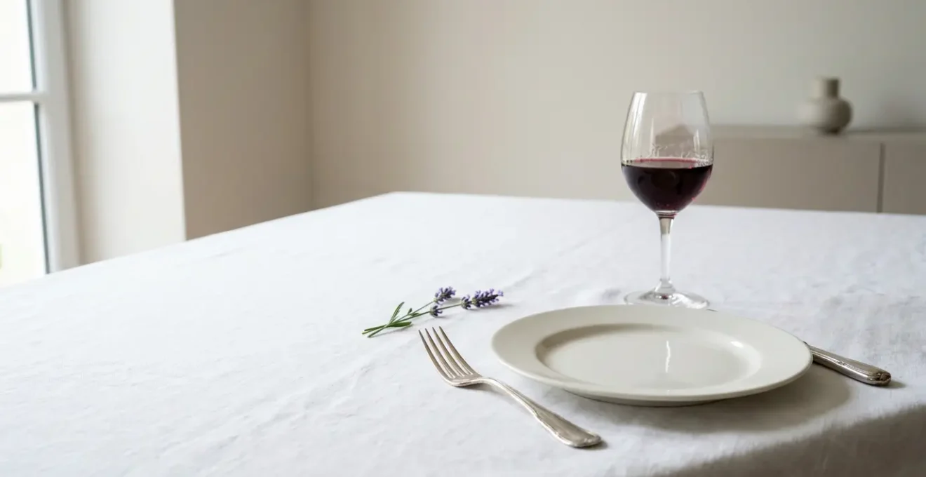 Elegant French table setting demonstrating sophisticated minimalism with intentional negative space and refined porcelain
