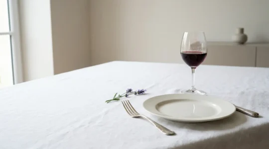 Elegant French table setting demonstrating sophisticated minimalism with intentional negative space and refined porcelain
