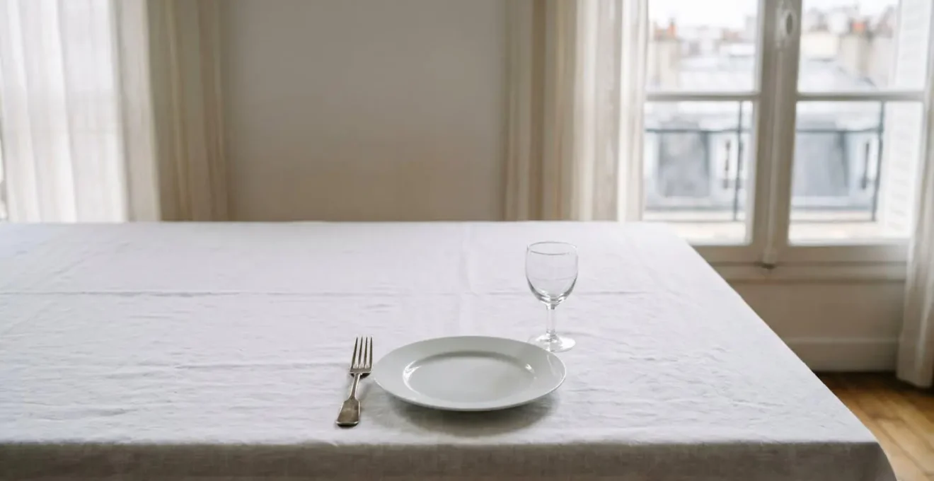 French table setting showcasing negative space design principle with sparse elegant elements creating visual calm