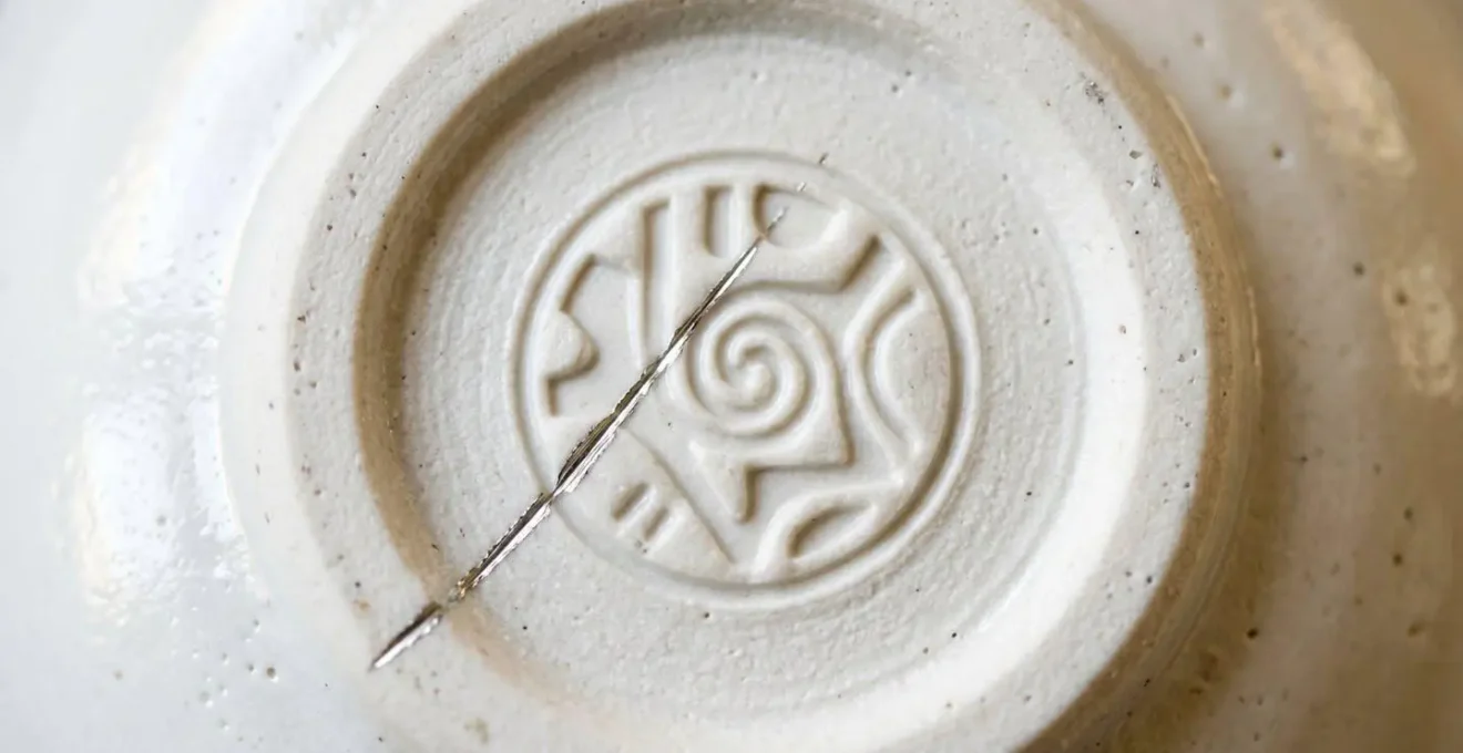 Macro photograph showing porcelain backstamp detail used to identify authentic versus second-quality Limoges pieces